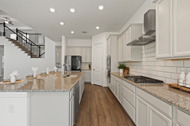 kitchen featuring white cabinetry, dark hardwood / wood-style floors, and wall chimney range hood