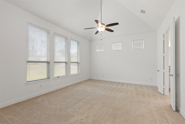 carpeted spare room featuring ceiling fan and vaulted ceiling