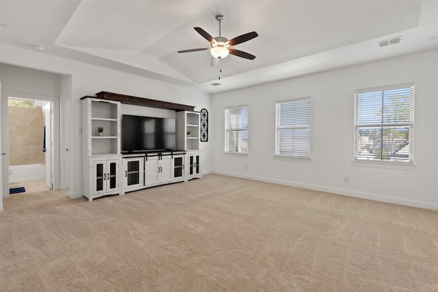 unfurnished living room with ceiling fan, light colored carpet, and lofted ceiling