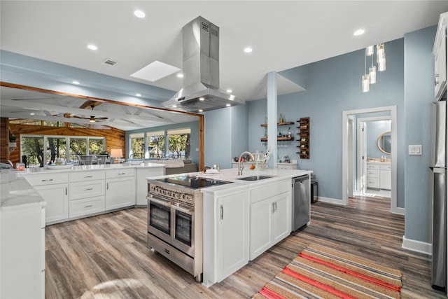 kitchen with white cabinetry, sink, appliances with stainless steel finishes, island exhaust hood, and light wood-type flooring