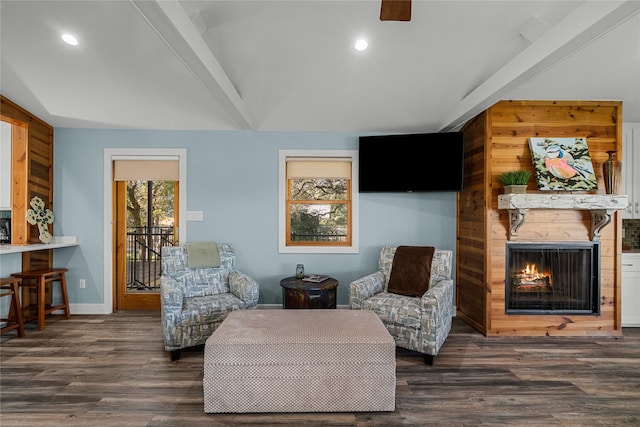 living area with beamed ceiling and dark hardwood / wood-style flooring