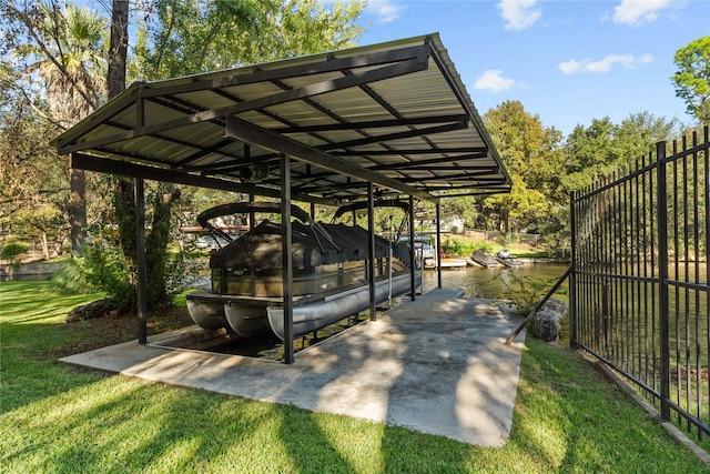 view of parking with a water view, a yard, and a carport