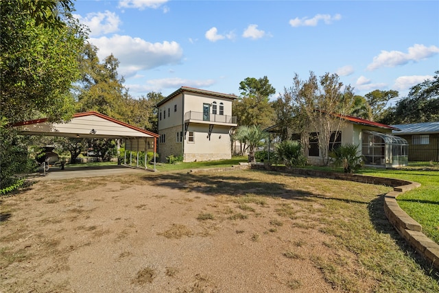 exterior space featuring a front yard and a carport