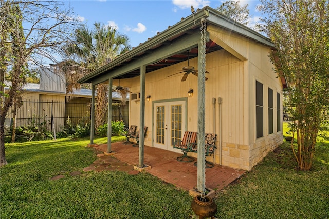 rear view of house featuring french doors, ceiling fan, a patio, and a yard