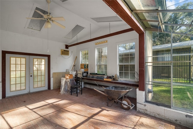 unfurnished sunroom with lofted ceiling, a wall unit AC, ceiling fan, and plenty of natural light