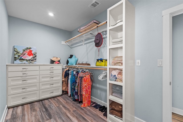 spacious closet featuring dark hardwood / wood-style floors