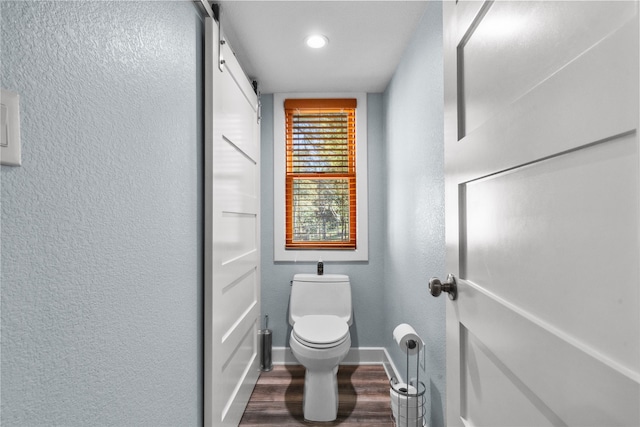 bathroom with toilet and hardwood / wood-style flooring