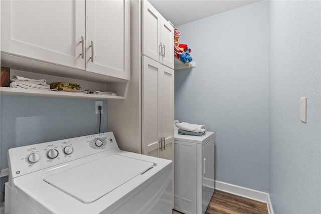 laundry area with cabinets, dark hardwood / wood-style floors, and washer and dryer