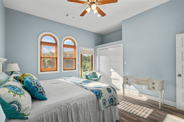 bedroom with wood-type flooring, ceiling fan, and a closet