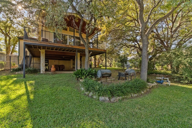 rear view of house with a yard, a patio, and stairs