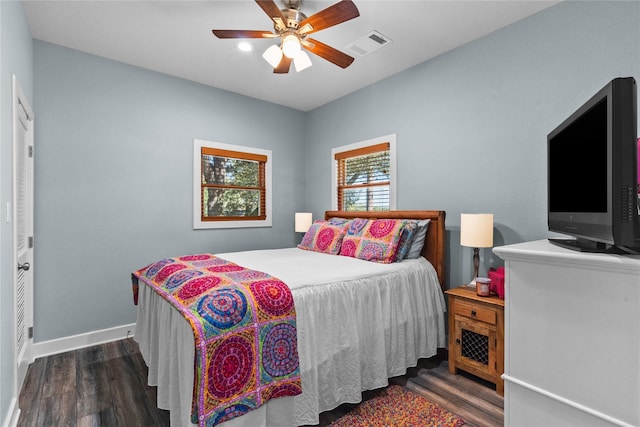 bedroom with visible vents, baseboards, a ceiling fan, and wood finished floors