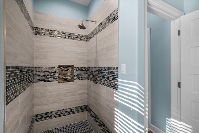 bathroom with tiled shower