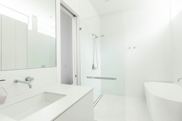 bathroom with backsplash, independent shower and bath, vanity, tile patterned floors, and tile walls