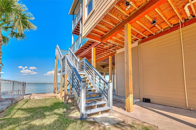 exterior space featuring a water view and a lawn