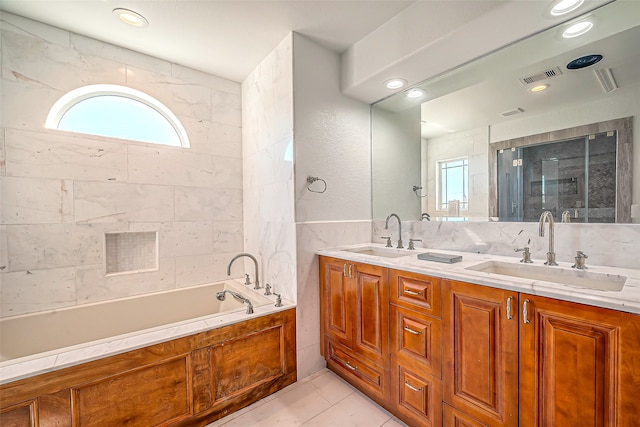 bathroom featuring vanity, tile patterned flooring, and a bathing tub