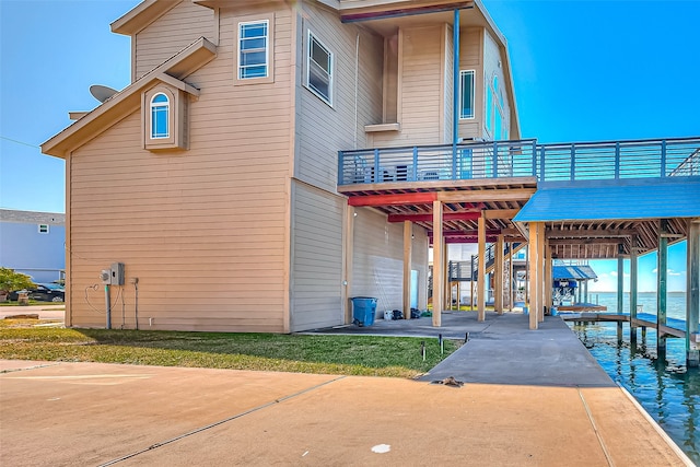 exterior space featuring a deck with water view