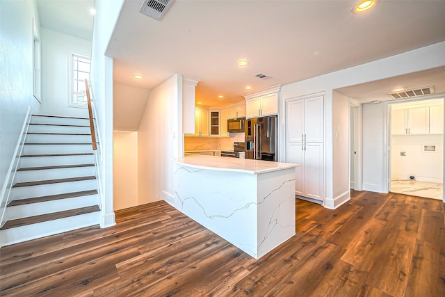 kitchen featuring dark wood-type flooring, white cabinets, kitchen peninsula, range with electric stovetop, and high end refrigerator