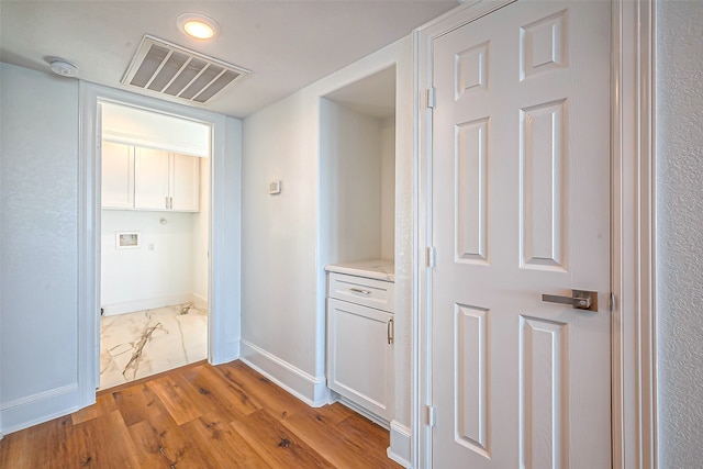 hall with light hardwood / wood-style flooring