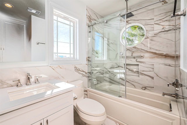 full bathroom featuring enclosed tub / shower combo, toilet, tile walls, decorative backsplash, and vanity