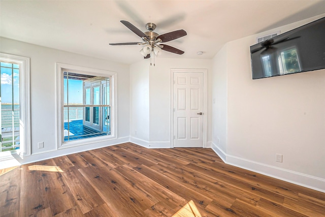 unfurnished room with hardwood / wood-style floors and ceiling fan