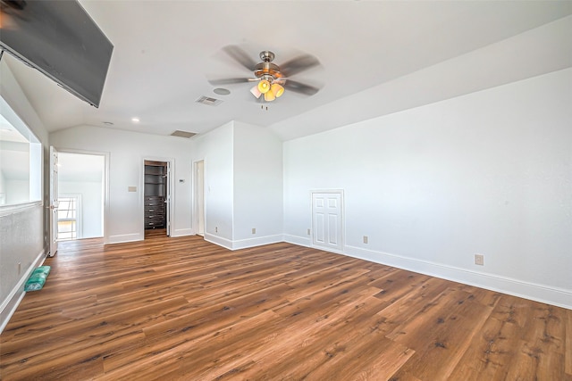 empty room with ceiling fan, dark hardwood / wood-style floors, and lofted ceiling