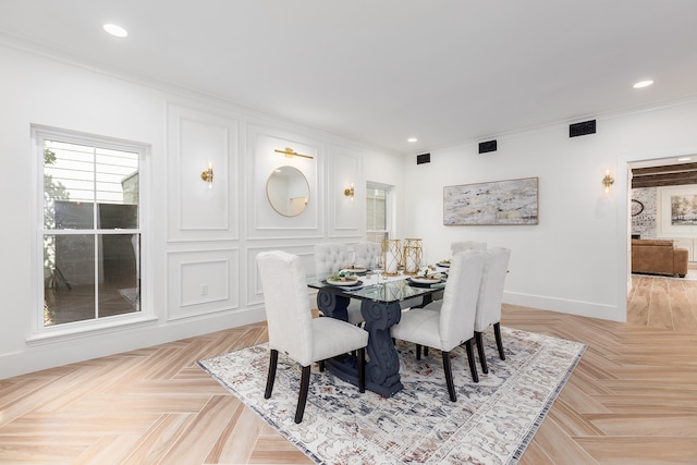 dining area with light parquet flooring and crown molding