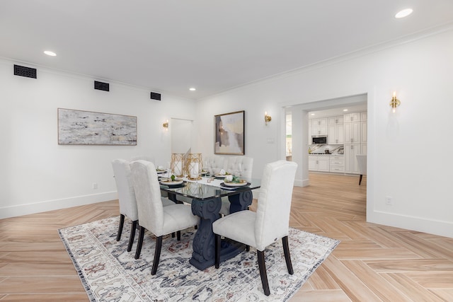 dining space featuring crown molding and light parquet flooring