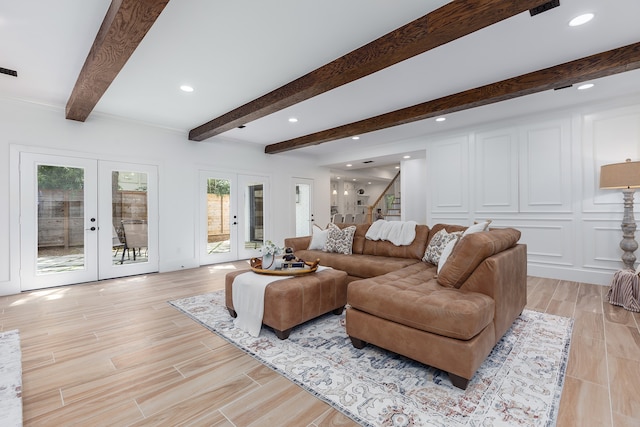 living room with french doors and beamed ceiling