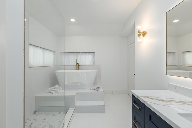 bathroom with vanity and a bathtub