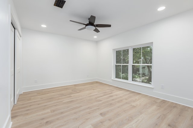 empty room featuring ceiling fan and light hardwood / wood-style flooring