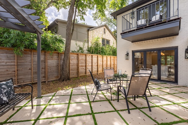 view of patio / terrace with a balcony and a pergola