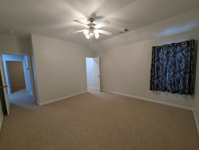 spare room featuring carpet flooring and ceiling fan