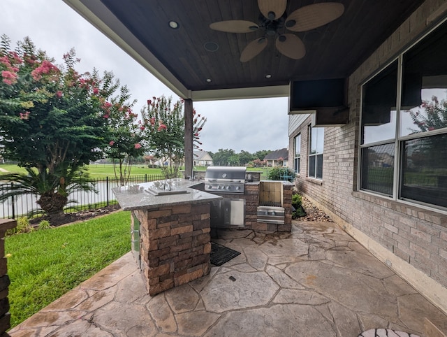 view of patio / terrace with ceiling fan, area for grilling, and a water view