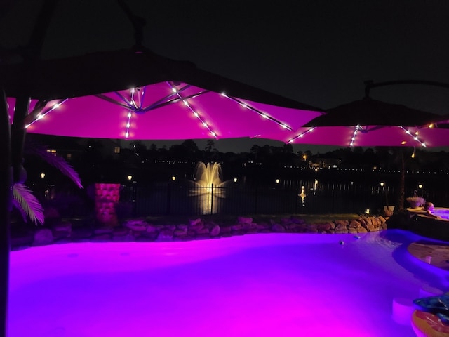 view of pool at night