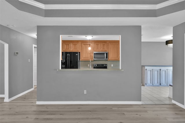 kitchen with black appliances, light wood-type flooring, kitchen peninsula, and ornamental molding