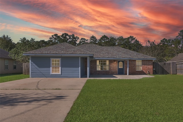 ranch-style home featuring a yard