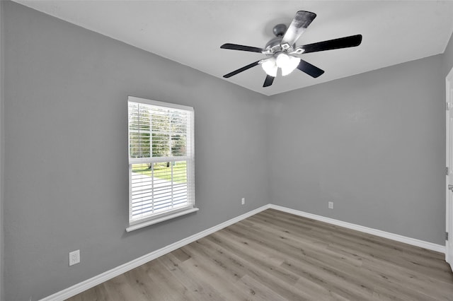 spare room with light wood-type flooring and ceiling fan