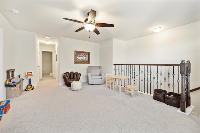 sitting room with carpet flooring and ceiling fan