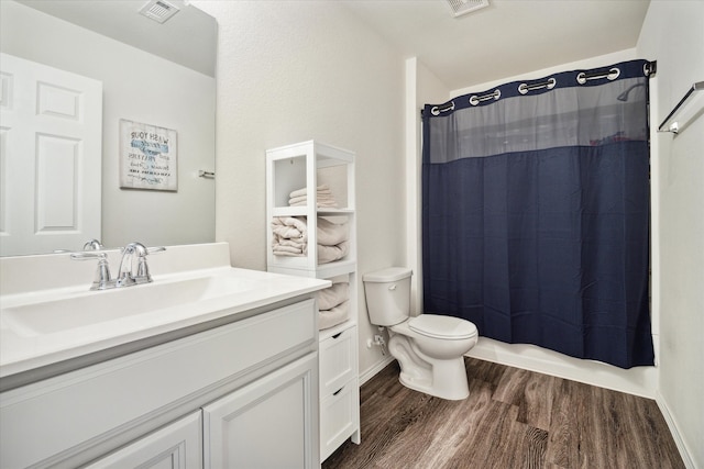 full bathroom with shower / bath combination with curtain, vanity, wood-type flooring, and toilet