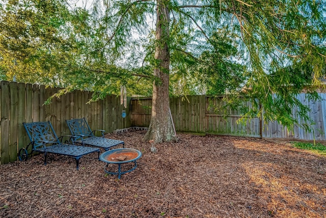 view of yard with an outdoor fire pit