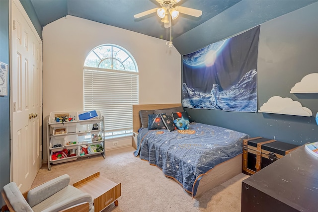 bedroom with ceiling fan, lofted ceiling, and carpet floors