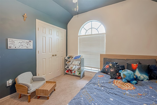 bedroom with vaulted ceiling, a closet, and carpet