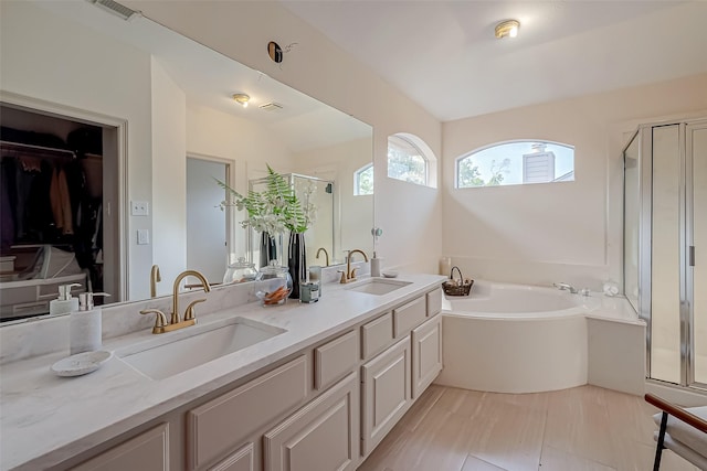 bathroom featuring independent shower and bath and vanity