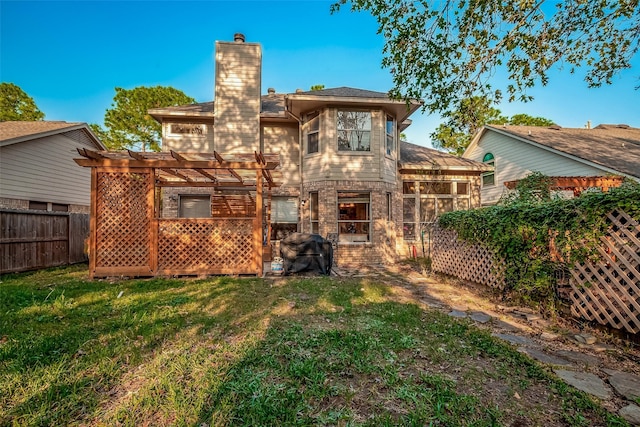 back of property with a pergola and a lawn