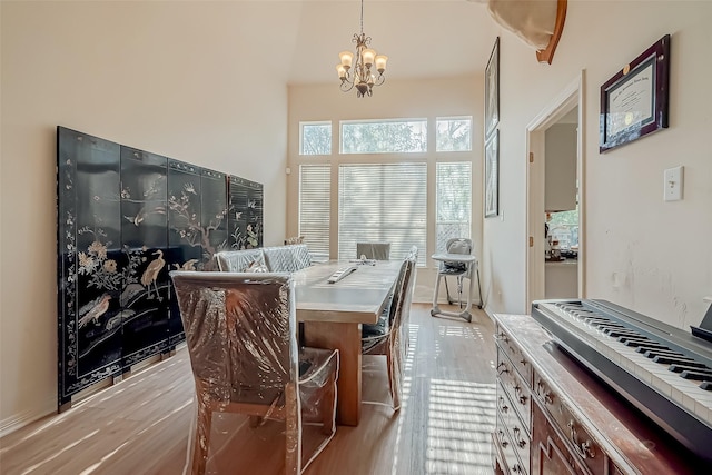 dining area with a chandelier and light hardwood / wood-style floors