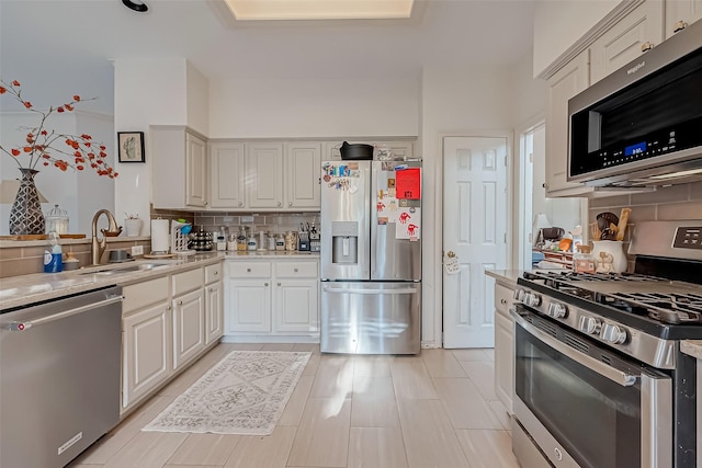 kitchen with sink, stainless steel appliances, and tasteful backsplash