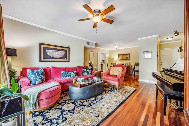 living room with hardwood / wood-style floors, ceiling fan, and ornamental molding