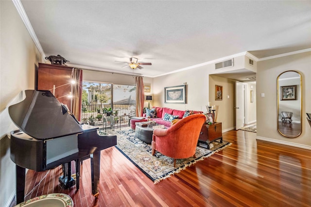 living room with ornamental molding, a textured ceiling, wood-type flooring, and ceiling fan