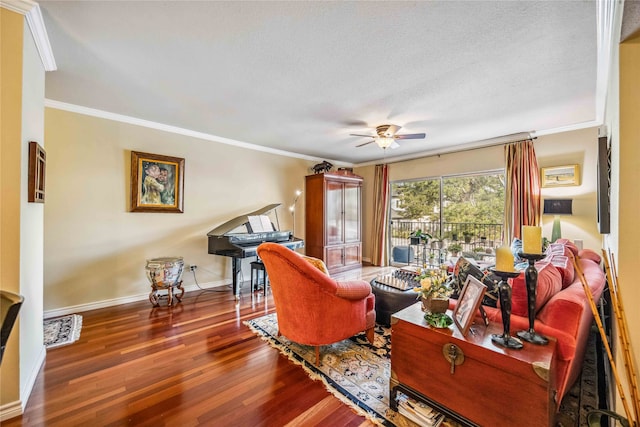 living room featuring ornamental molding, ceiling fan, a textured ceiling, and dark hardwood / wood-style floors