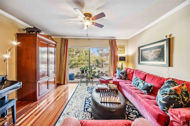 living room with ornamental molding, light hardwood / wood-style flooring, a textured ceiling, and ceiling fan